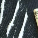 Lines of cocaine and a rolled up dollar bill
