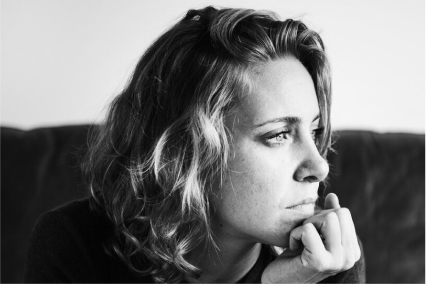 A black and white photo of a woman thinking about Risperidone Withdrawal