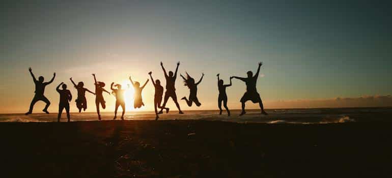 A group of people jumping on the beach