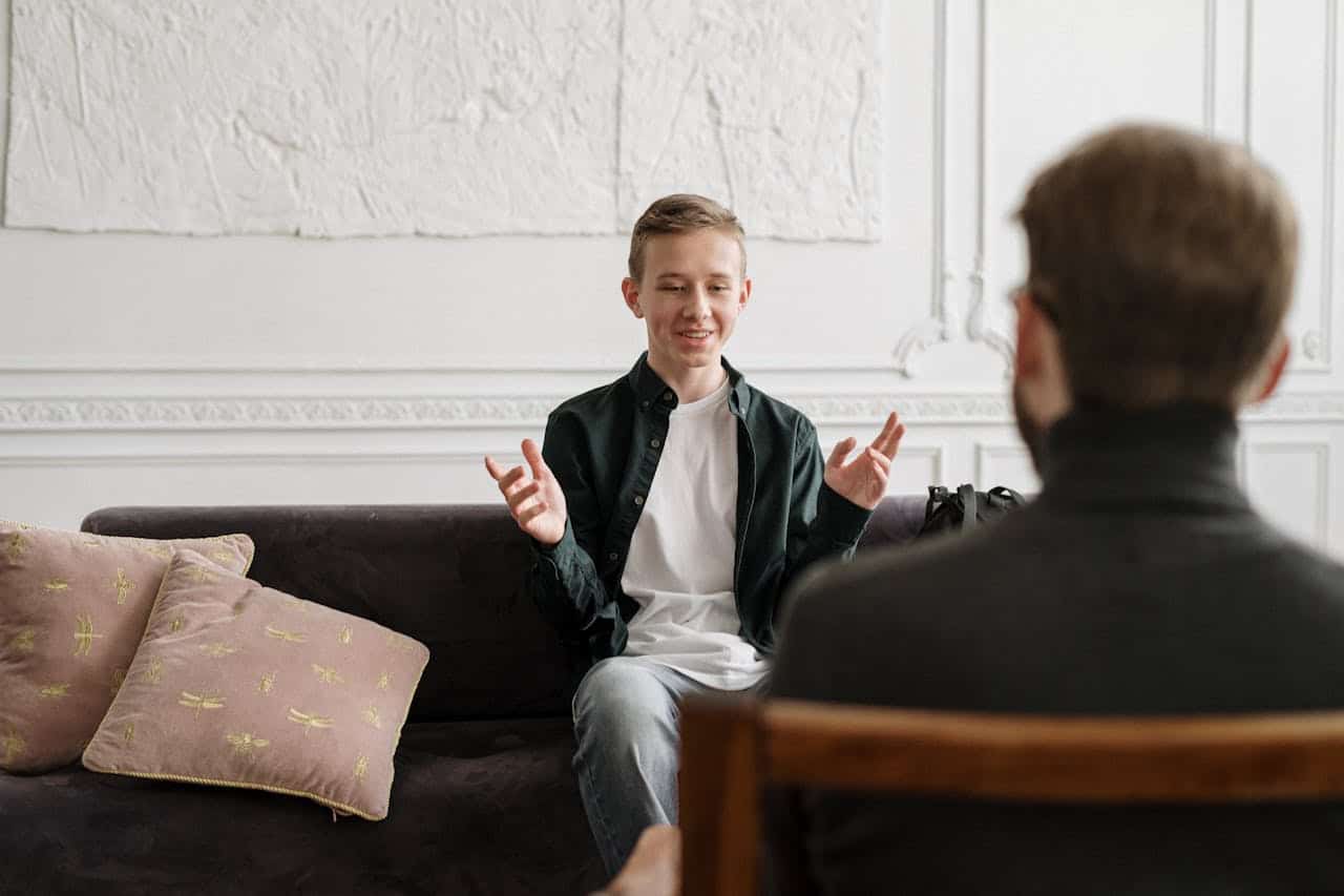 A teenager talking to a therapist