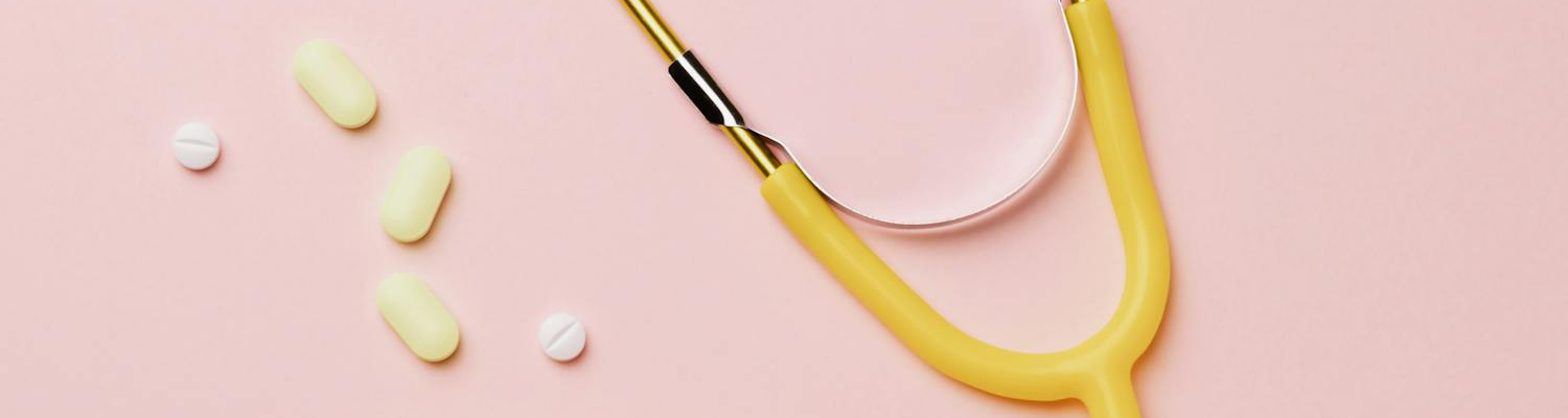 Pills and stethoscope on a pink surface representing medical California heroin detox center