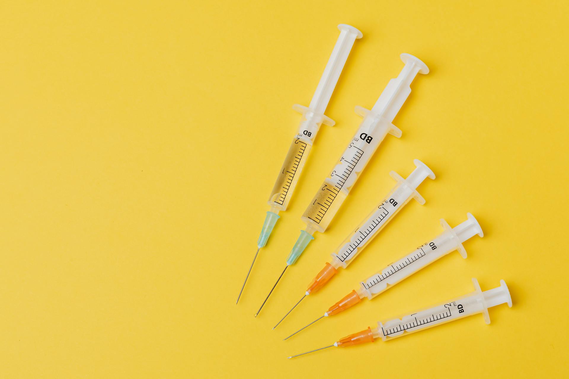 Syringes on a yellow background