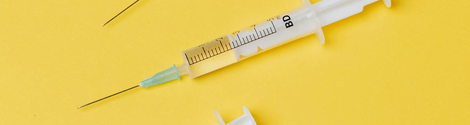 Full syringes on a yellow surface