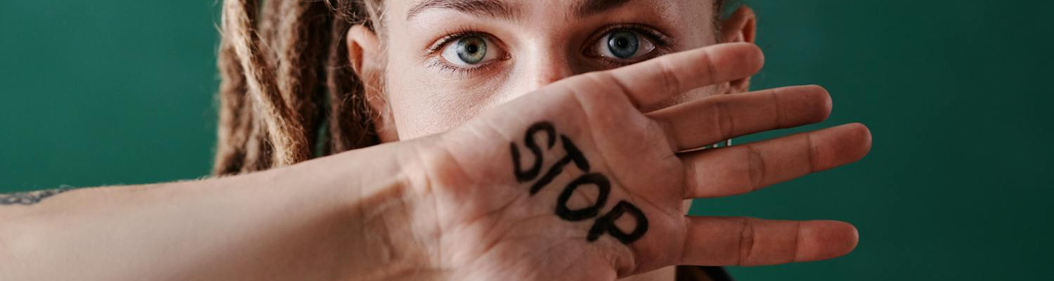 STOP written on a woman´s palm.