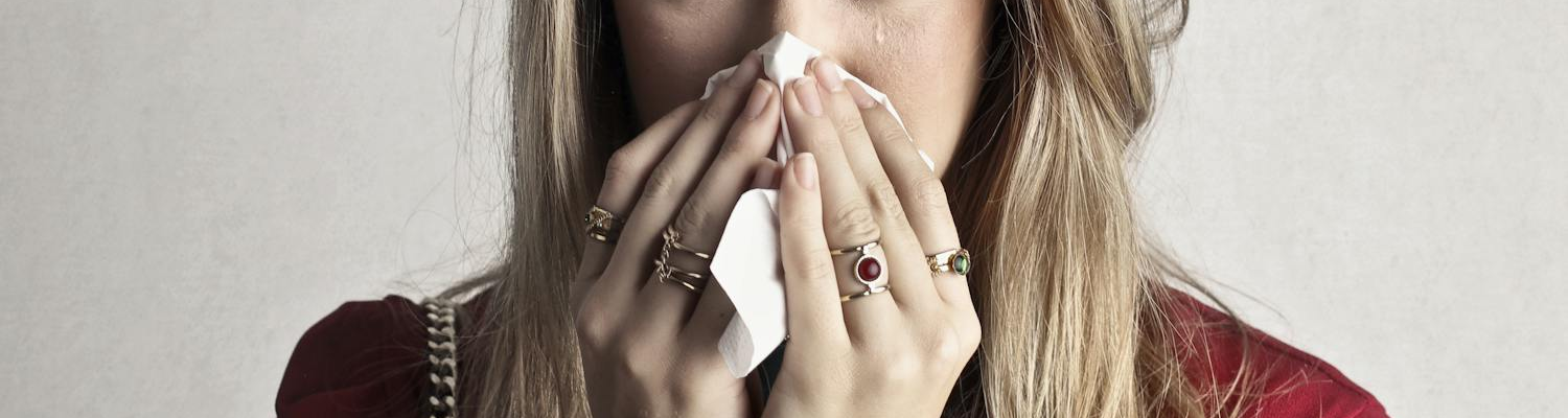 A woman with a runny nose, one of the Risperidone withdrawal symptoms.