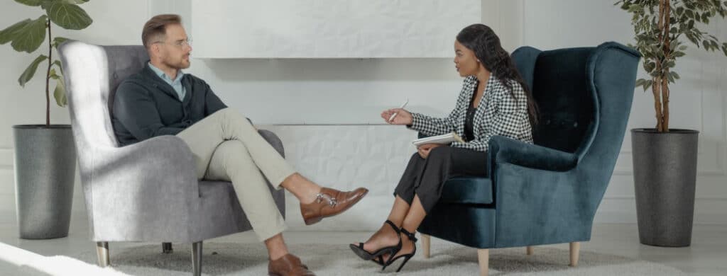 A therapist talking to a person during a session